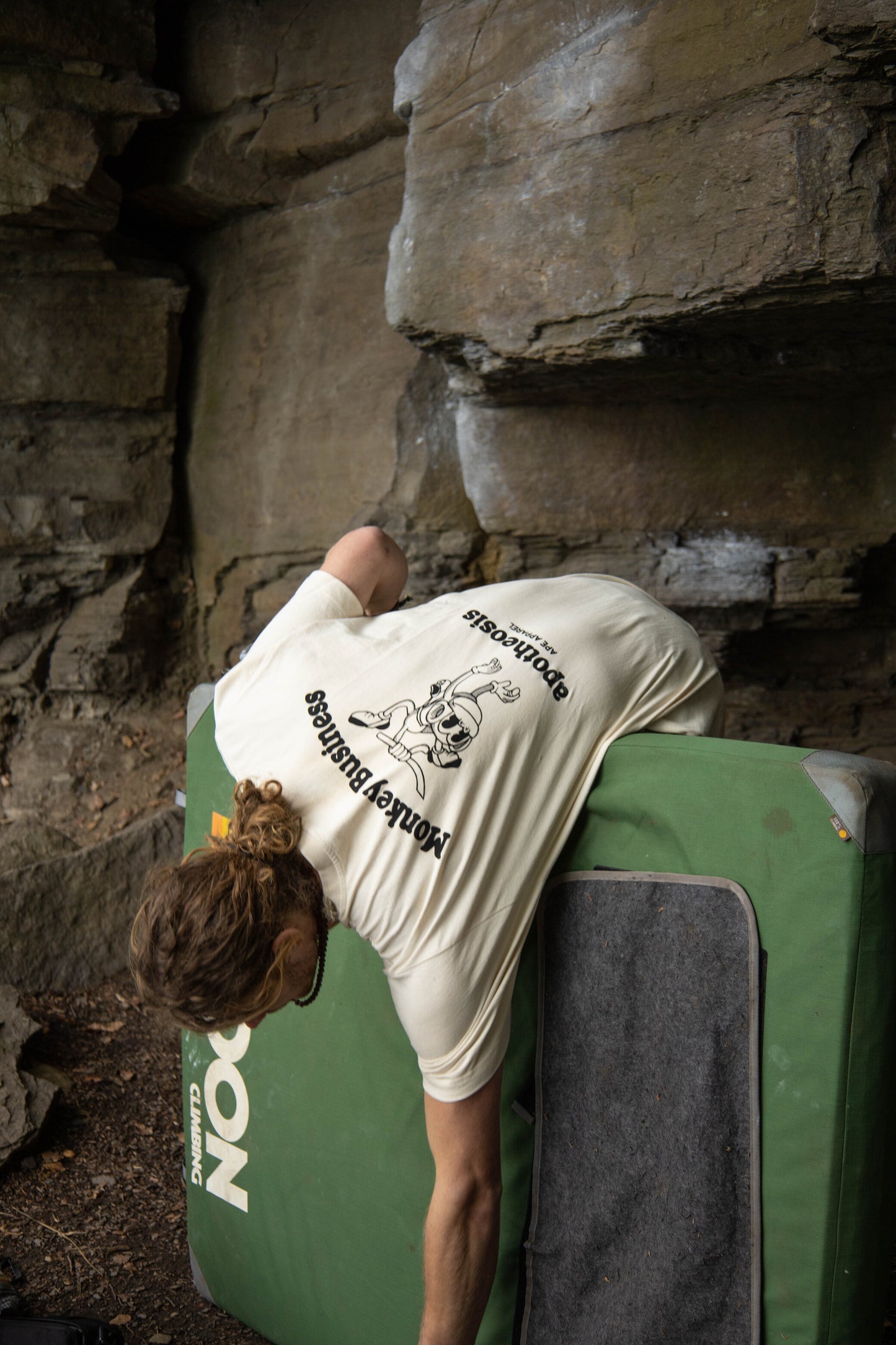 Back of monkey business tee while outdoor bouldering, model is wearing an L